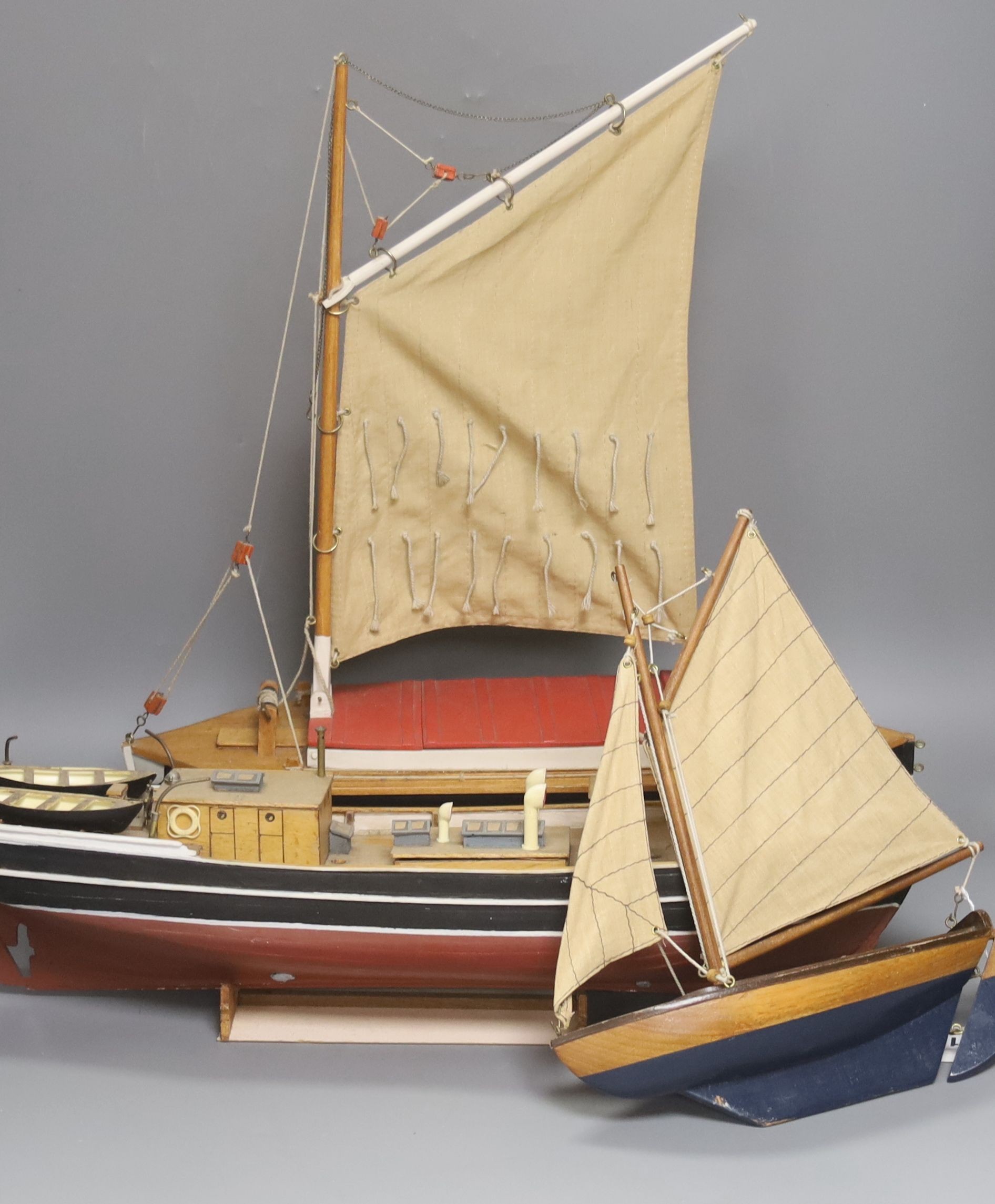 Two pond yachts and a model of a ship, longest 51.5 cm